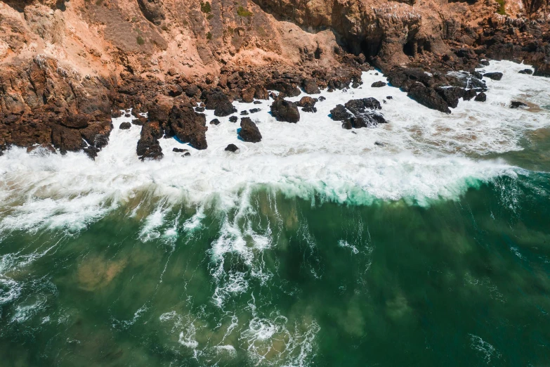 a large body of water next to a rocky shore, pexels contest winner, happening, close-up from above, malibu canyon, thumbnail, nazare (portugal)