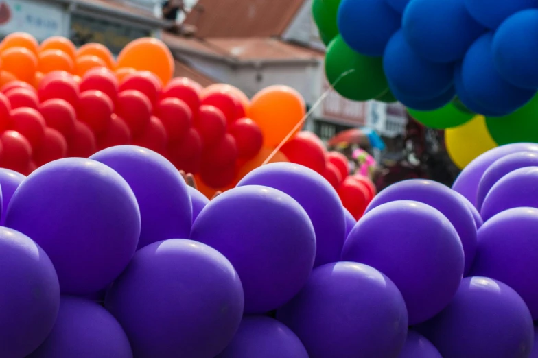 a bunch of balloons that are next to each other, by Niko Henrichon, pexels contest winner, pride parade, purple tubes, profile image, solid coloured shapes