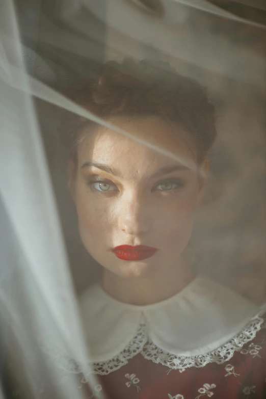 a close up of a woman with a veil over her head, a portrait, inspired by Elsa Bleda, unsplash contest winner, renaissance, red lips, vintage color photo, bride, high cheekbones