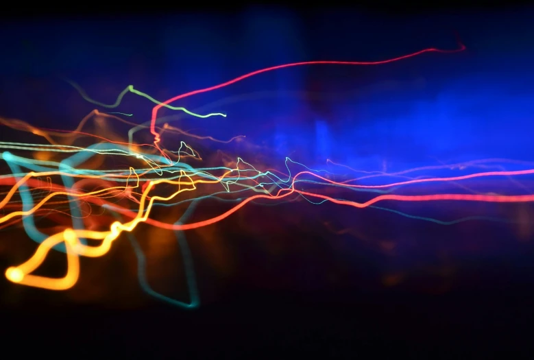 a blurry photo of a street at night, a microscopic photo, by Jan Rustem, pexels, lyrical abstraction, colorful wires, energy waves, blue and red lighting, electric wallpaper