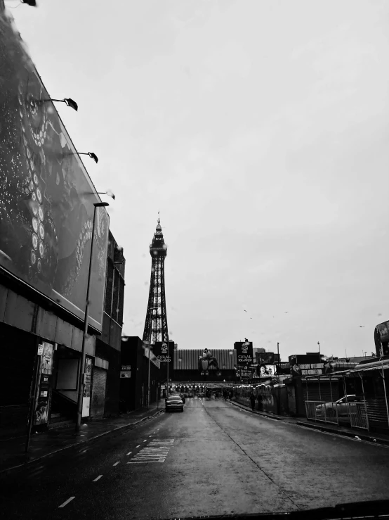 a black and white photo of a city street, a black and white photo, inspired by Thomas Struth, unsplash, a crystal palace, rusted silent hill, seaside, tower