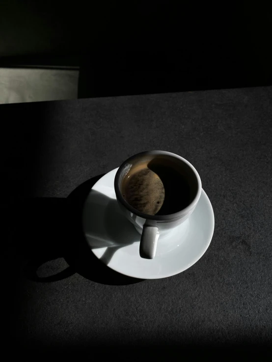 a cup of coffee sitting on top of a saucer, by Harvey Quaytman, alessio albi, contre jour, profile image