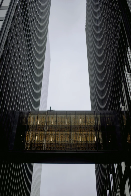 a couple of tall buildings next to each other, inspired by René Burri, modernism, eyelevel perspective image, louis sullivan, 1987 photograph, exterior