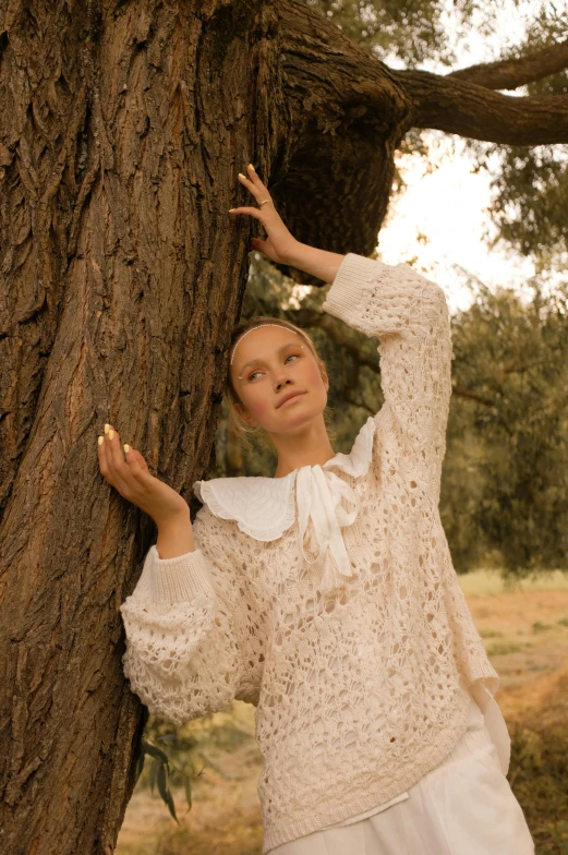 a woman leaning against a tree in a field, an album cover, inspired by Konstantin Somov, unsplash, renaissance, cream colored peasant shirt, elle fanning), ivory carved ruff, wearing nanotech honeycomb robe