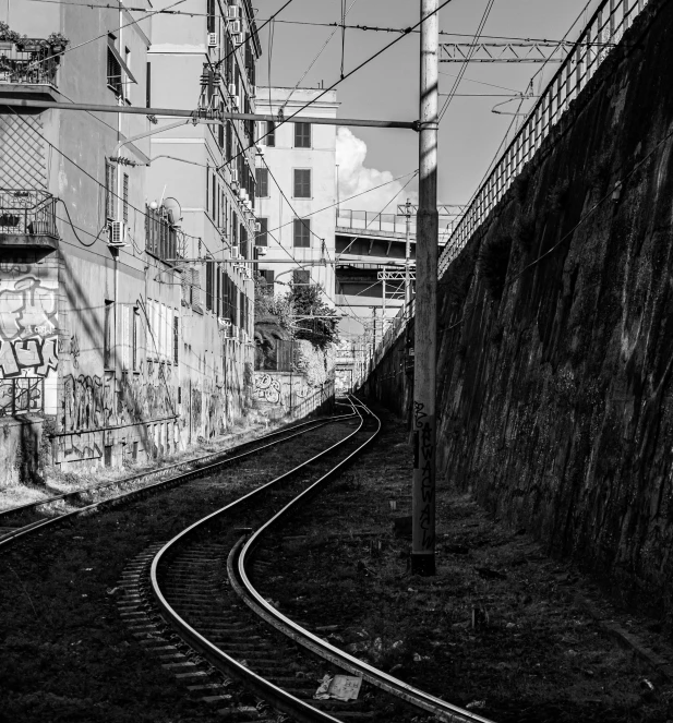 a black and white photo of a train track, a black and white photo, by Patrick Pietropoli, location ( favela _ wall ), vectorial curves, naples, realistic photo