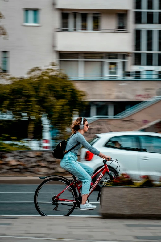 a woman riding a bike on a city street, by Niko Henrichon, pexels contest winner, happening, north melbourne street, 🚿🗝📝, hannover, at full stride