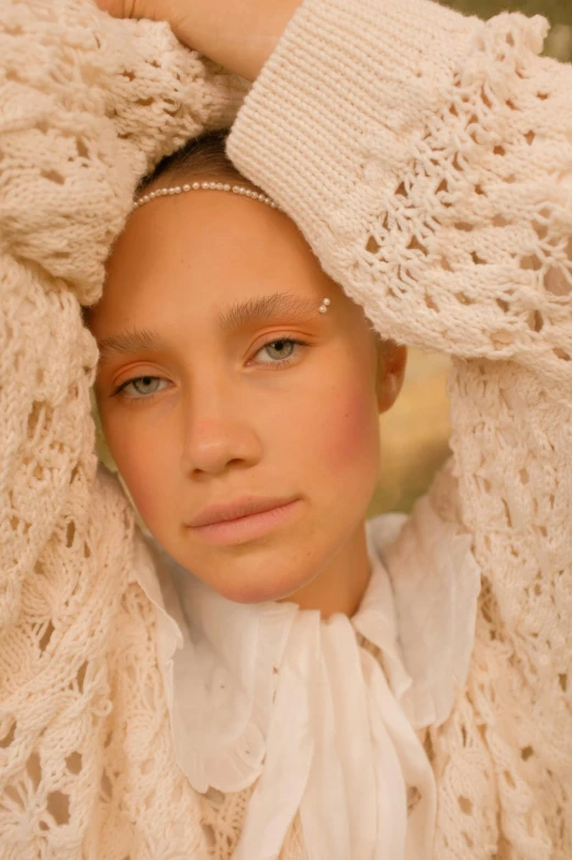 a close up of a person wearing a sweater, an album cover, inspired by Sophie Anderson, renaissance, photoshoot for vogue magazine, white scarf, honey - colored eyes, soft light 8 k