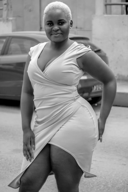 a black and white photo of a woman in a dress, inspired by Esaias Boursse, flickr, thicc, african, wearing tight simple clothes, curves!!