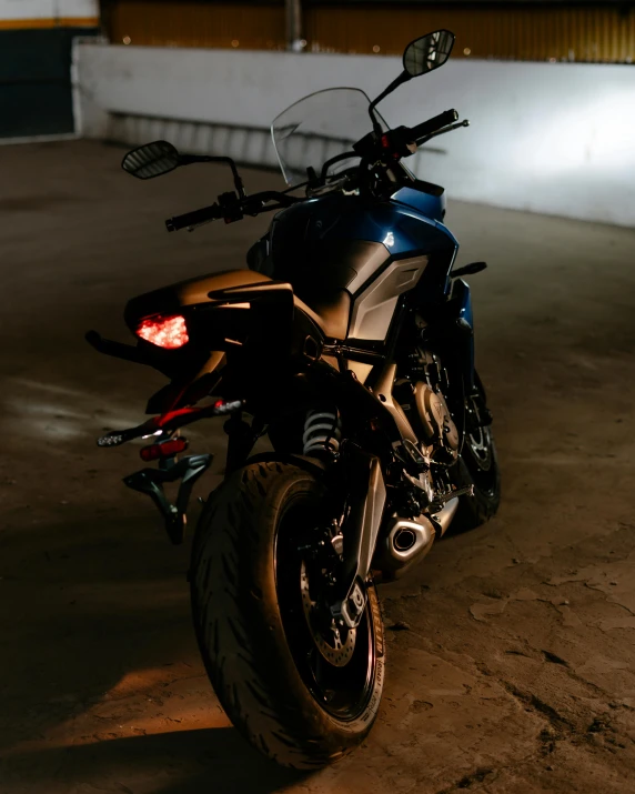 a motorcycle parked in a parking lot at night, at night time, profile image, dark blue skin, trending photo