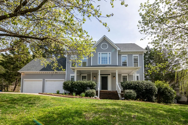 a house with a lawn in front of it, a picture, by Carey Morris, shutterstock, fan favorite, photograph of april, carson ellis, view from front