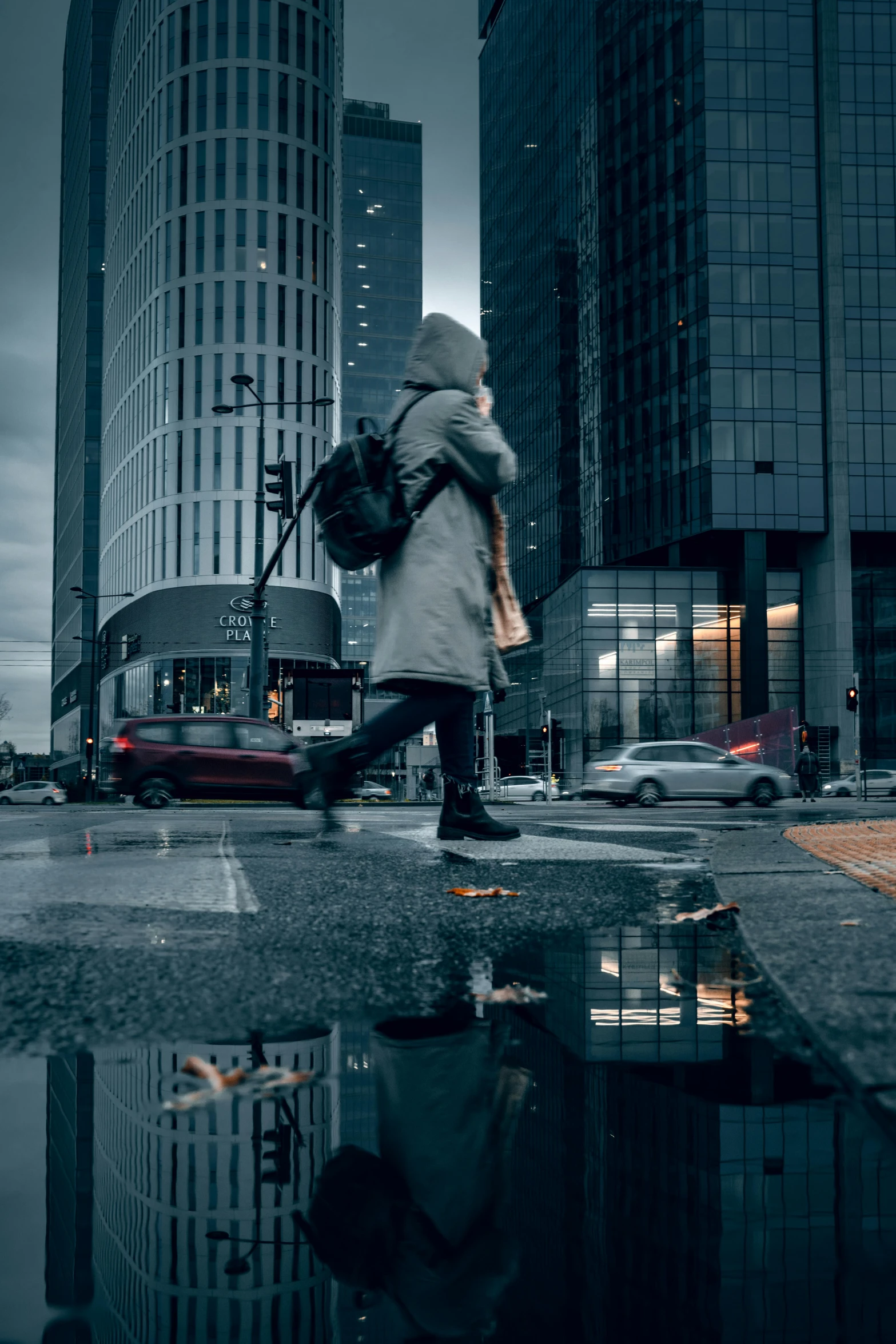 a person walking across a city street in the rain, by Tobias Stimmer, ultrawide cinematic, wet reflective ground, high rises, city morning