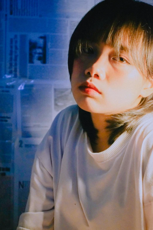 a young boy sitting in front of a refrigerator, an album cover, inspired by Xia Yong, unsplash, realism, 🤤 girl portrait, bluish face, nishimiya shouko, low quality grainy