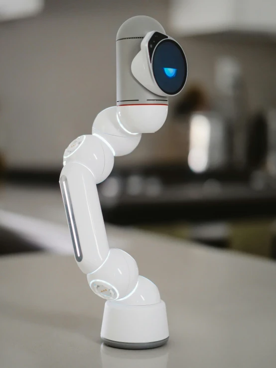 a white robot sitting on top of a counter, plated arm, eye level view, bixbite, sleek white