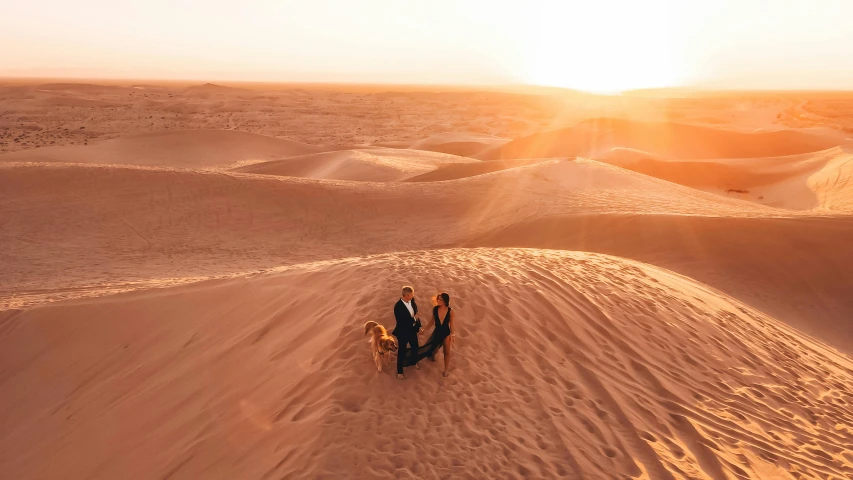 a group of people riding a camel in the desert, pexels contest winner, les nabis, gorgeous romantic sunset, flatlay, youtube thumbnail, tanned ameera al taweel