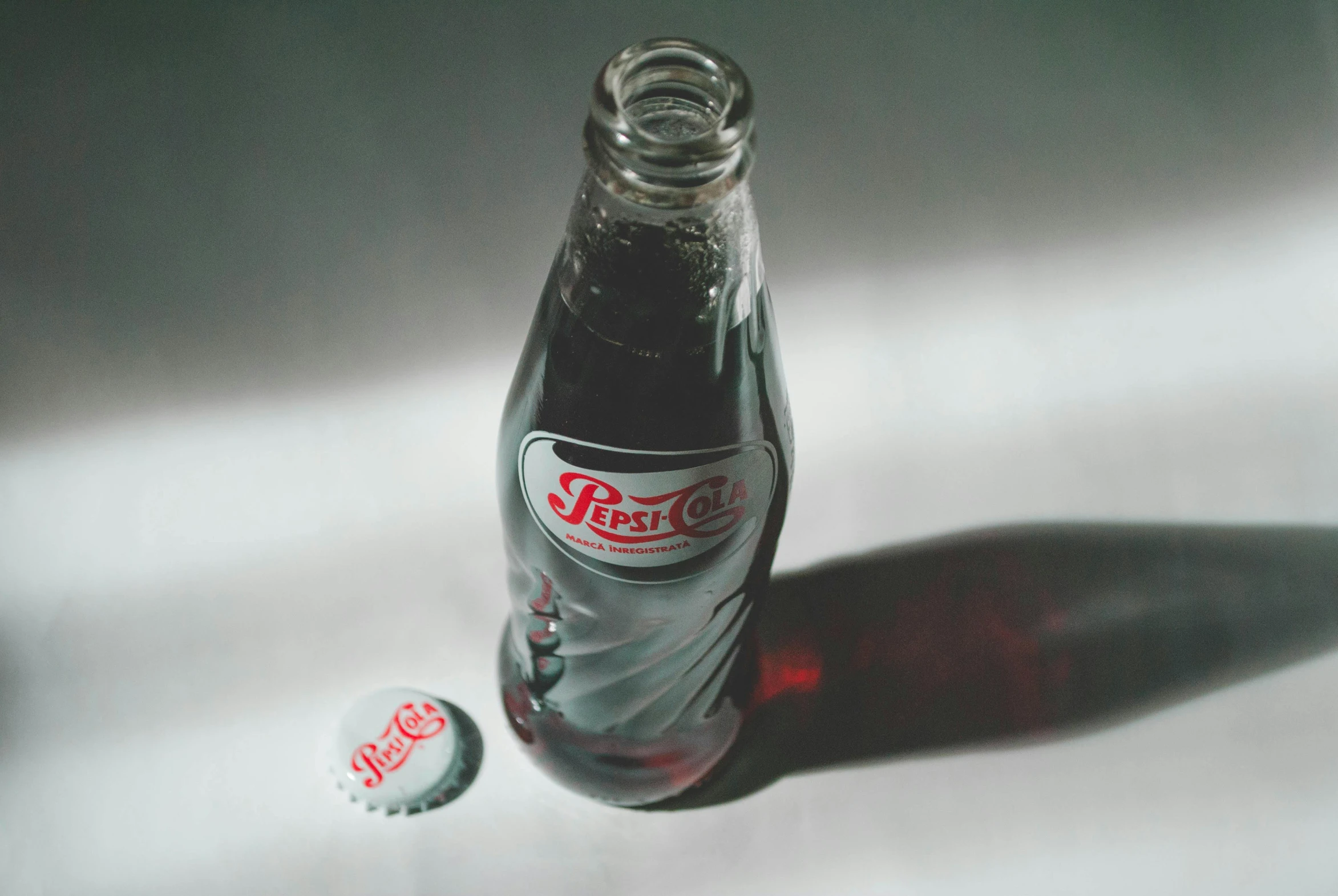 a bottle of coke sitting on top of a table, pexels contest winner, hyperrealism, 1990s photograph, round bottle, ilustration, pepsi