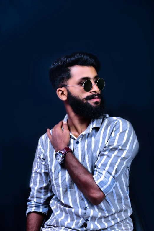 a man with a beard sitting on a chair, trending on pexels, assamese aesthetic, non binary model, stripes, headshot profile picture