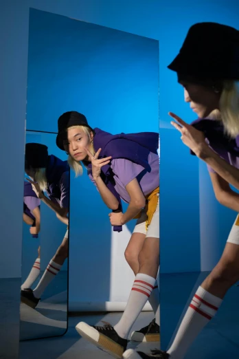a woman that is standing in front of a mirror, inspired by Cindy Sherman, wearing a purple cap, males and females breakdancing, portrait of kim petras, nonbinary model