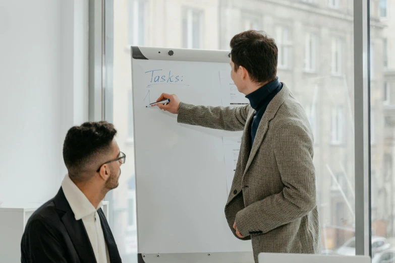 a man giving a presentation to a group of people, pexels contest winner, renaissance, whiteboard, two men, background image