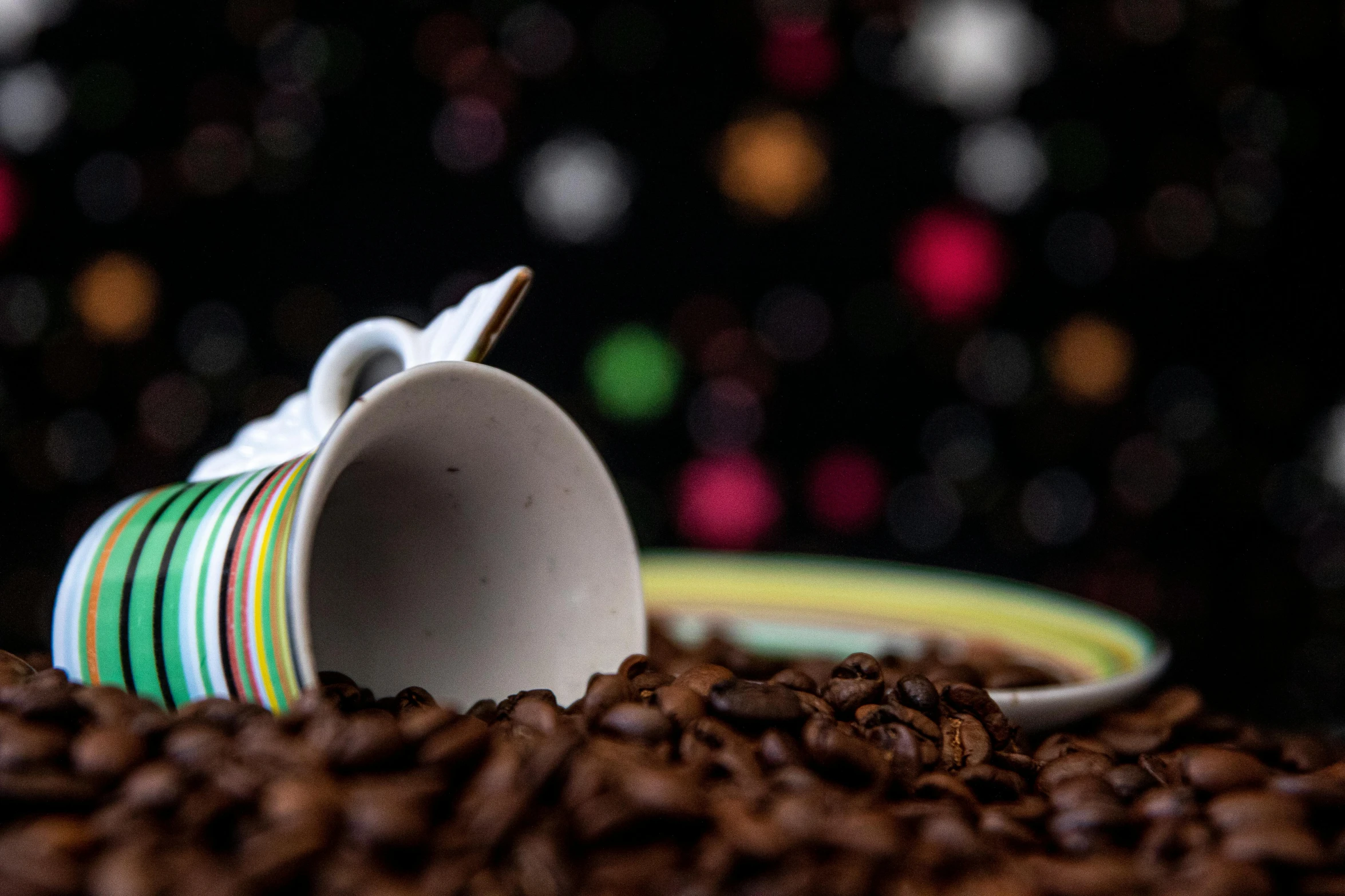 a coffee cup sitting on top of a pile of coffee beans, by Julia Pishtar, pexels contest winner, night life, multi - coloured, medium closeup, multiple stories