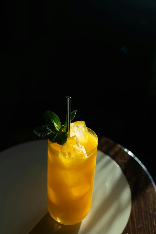 a drink sitting on top of a white plate, mango, ivy's, spotlight, tall shot