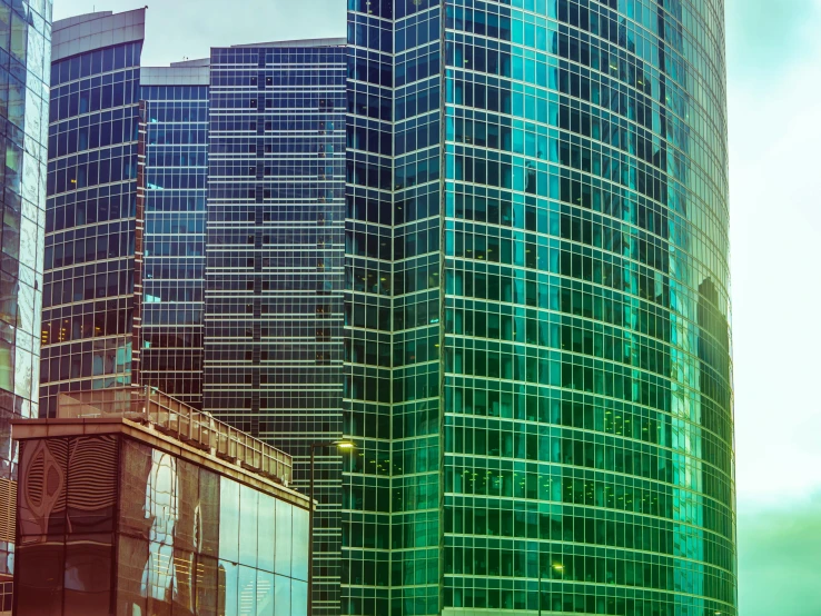 a group of tall buildings sitting next to each other, a screenshot, pexels contest winner, panfuturism, glass and gold and jade, nice colors, a green, postprocessed