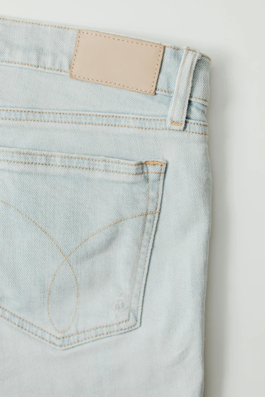 the back pocket of a pair of light blue jeans, inspired by Johann Christian Brand, happening, calvin klein, viewed from bird's-eye, pale colors, in 2 0 1 5