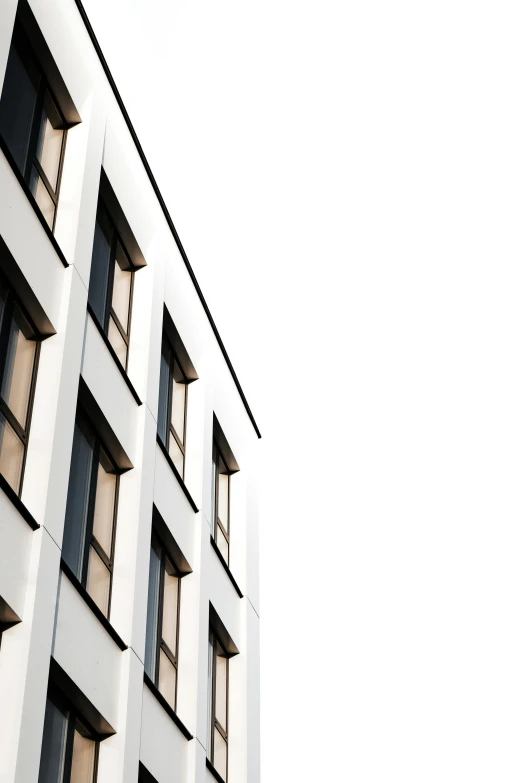 a tall white building with lots of windows, a photo, unsplash, modernism, white background wall, uploaded, window, ten flats