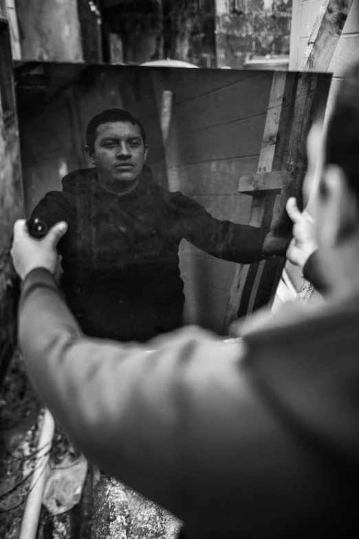 a man taking a picture of himself in a mirror, inspired by Larry Fink, realism, hand to hand combat with machete, eloy morales, ((portrait)), dramatic movie still