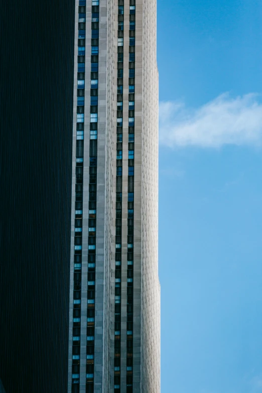 a tall building sitting in the middle of a city, unsplash, postminimalism, close - up profile, portra 8 0 0 ”, trending photo, under blue clouds