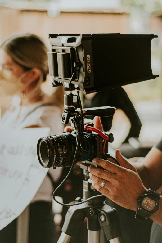 a man holding a camera on top of a tripod, pexels contest winner, video art, meet the actor behind the scenes, commercial banner, closeup headshot, handcrafted