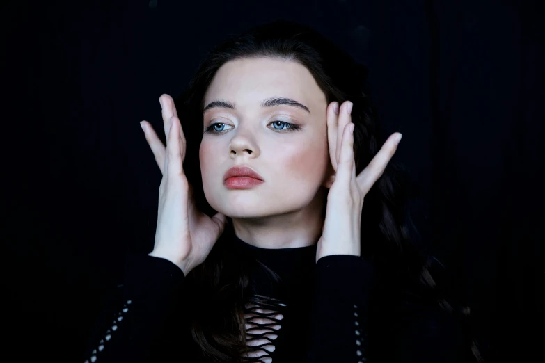 a woman holding her hands up to her face, instagram, antipodeans, joey king, portrait. 8 k high definition, 8k hq, cynthwave