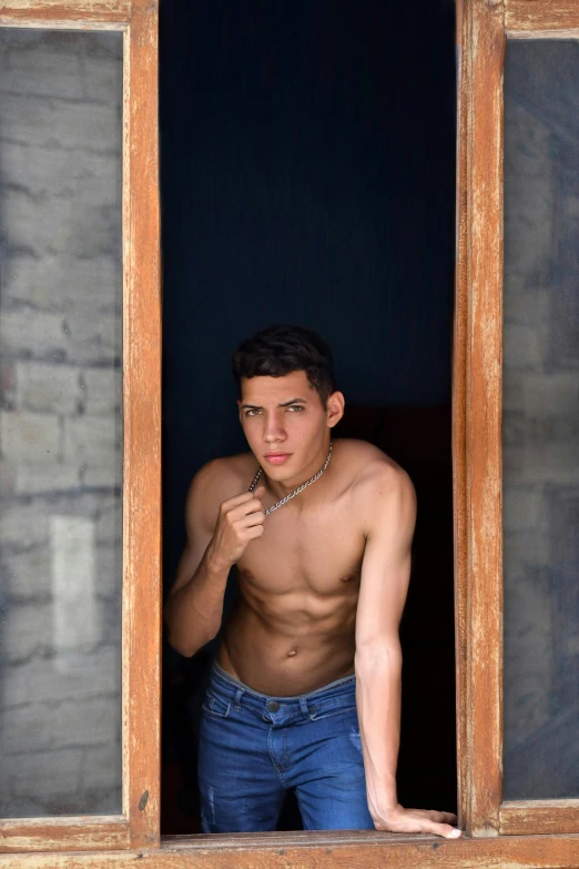 a shirtless man is looking out of a window, by Jean Xceron, tachisme, peruvian boy looking, high quality photo, male teenager, frontal pose