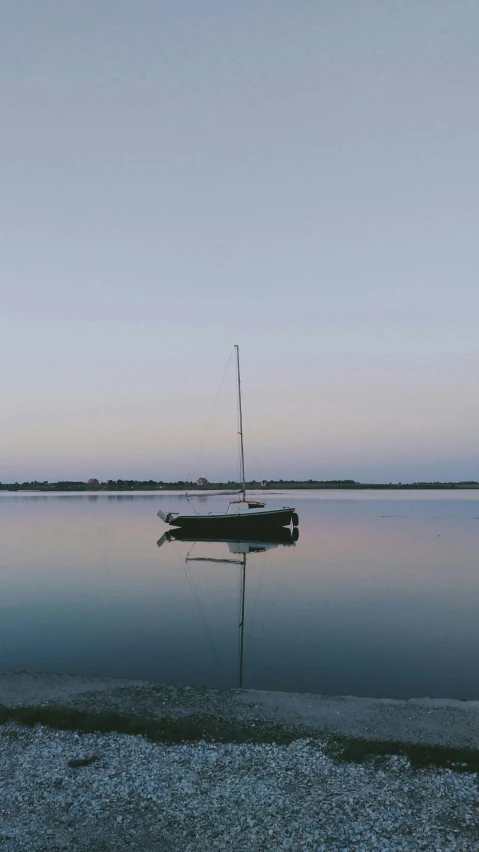 a boat sitting on top of a body of water, by Winona Nelson, pexels, minimalism, peaceful evening harbor, medium format. soft light, high quality photo, sailboat