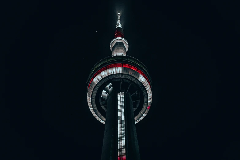 the top of a tall tower lit up at night, pexels contest winner, hurufiyya, toronto city, it has a red and black paint, instagram post, high quality upload