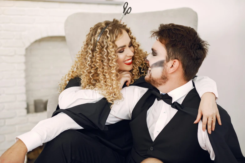 a woman sitting next to a man in a tuxedo, trending on pexels, romanticism, halloween theme, curly blonde hair | d & d, avatar image