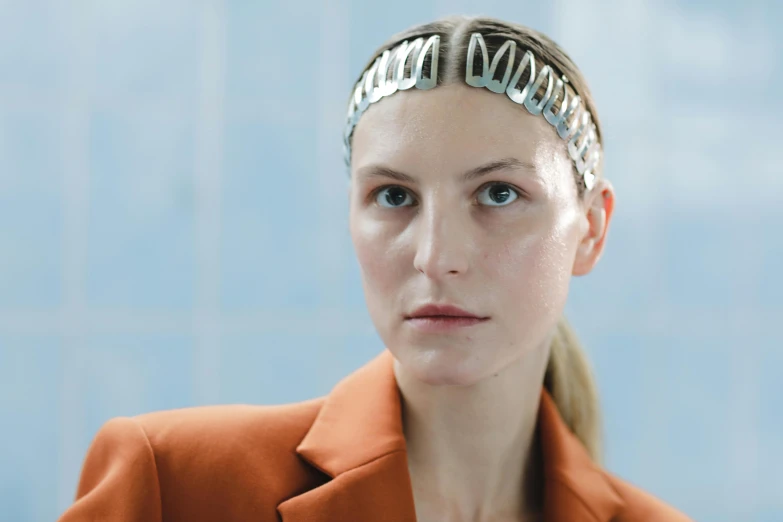 a close up of a person wearing a headband, by Nina Hamnett, trending on pexels, bauhaus, made of paperclips, silver crown, at a fashion shoot, a blond