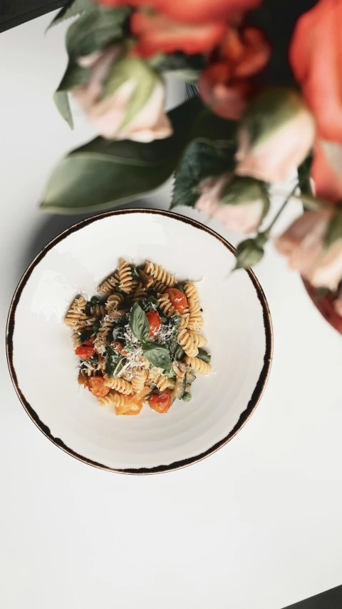 a close up of a plate of food on a table, pexels contest winner, renaissance, pasta, petals, mint, with a white background