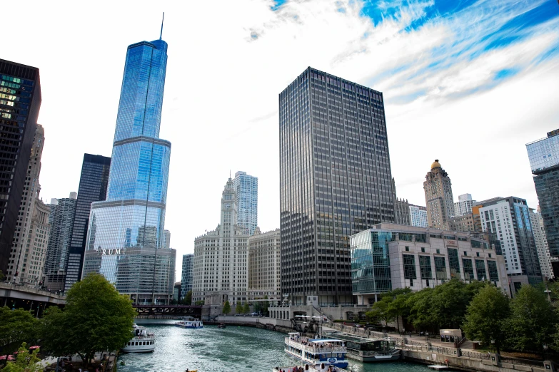 a river running through a city next to tall buildings, chicago skyline, thumbnail, hziulquoigmnzhah