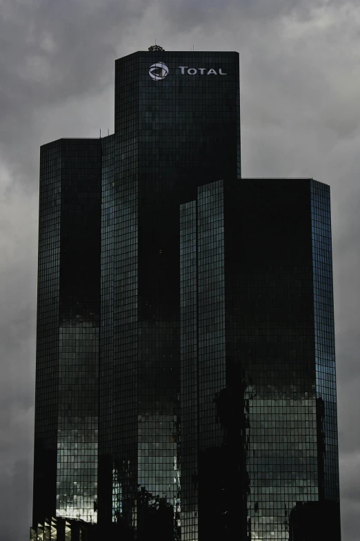 a couple of tall buildings sitting next to each other, an album cover, inspired by David Chipperfield, flickr, dark ominous stealth, capital plaza, gm, ap news photo
