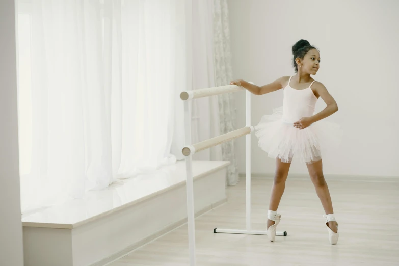 a little girl that is standing in a room, pexels contest winner, arabesque, samuel l. jackson as a ballerina, white, premium quality, no legs