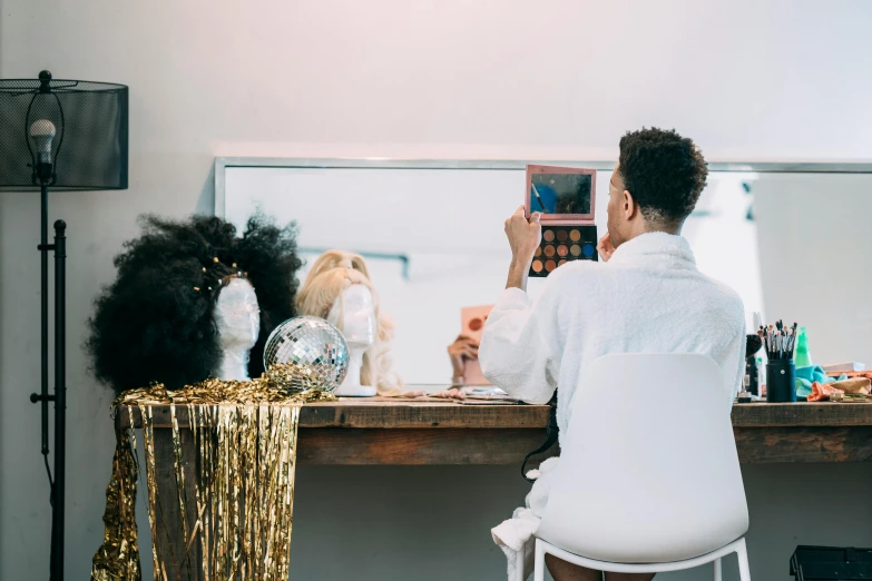 a woman sitting at a desk in front of a mirror, glam hair, millennial vibes, performing, profile image