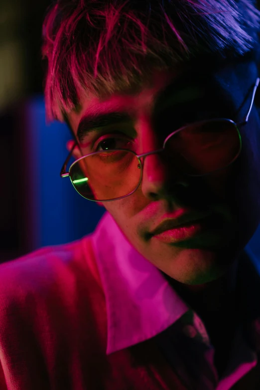 a close up of a person wearing glasses, trending on pexels, neo-fauvism, cinematic neon uplighting, justin bieber, young spanish man, bisexual lighting
