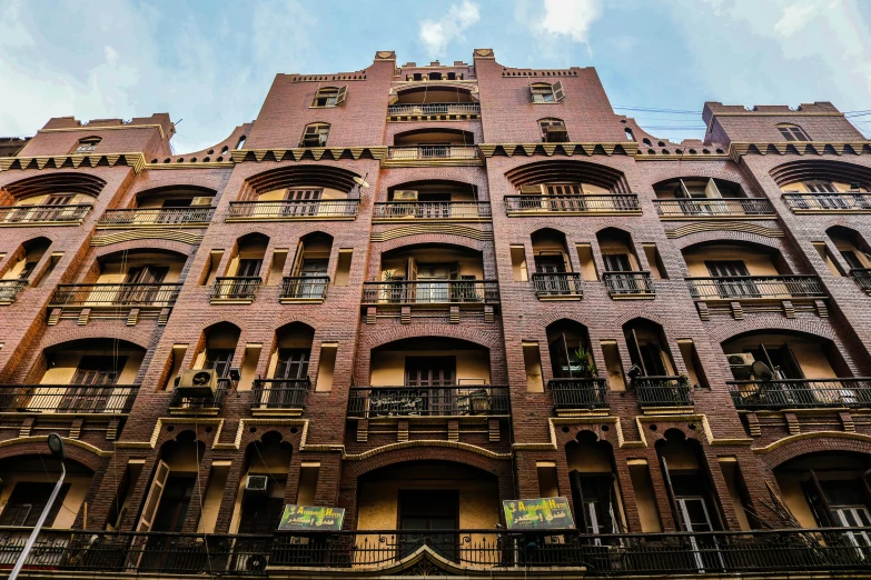 a tall building with lots of windows and balconies, pexels contest winner, art nouveau, talaat harb square cairo, brick building, profile image, restored