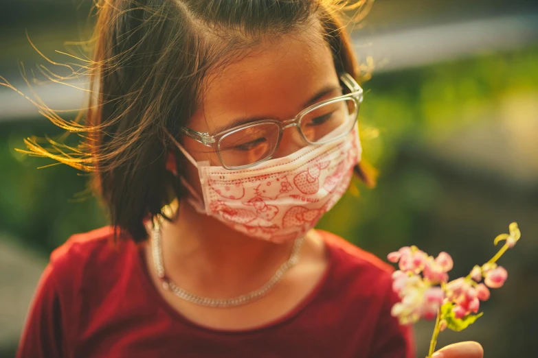 a little girl wearing a face mask and holding a flower, pexels contest winner, girl with glasses, avatar image, asian descent, environmental