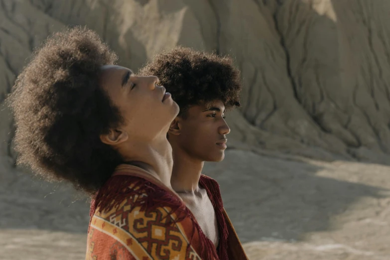 a couple of young men standing next to each other, afrofuturism, dune (2021), beautiful boy, cliffside, documentary still