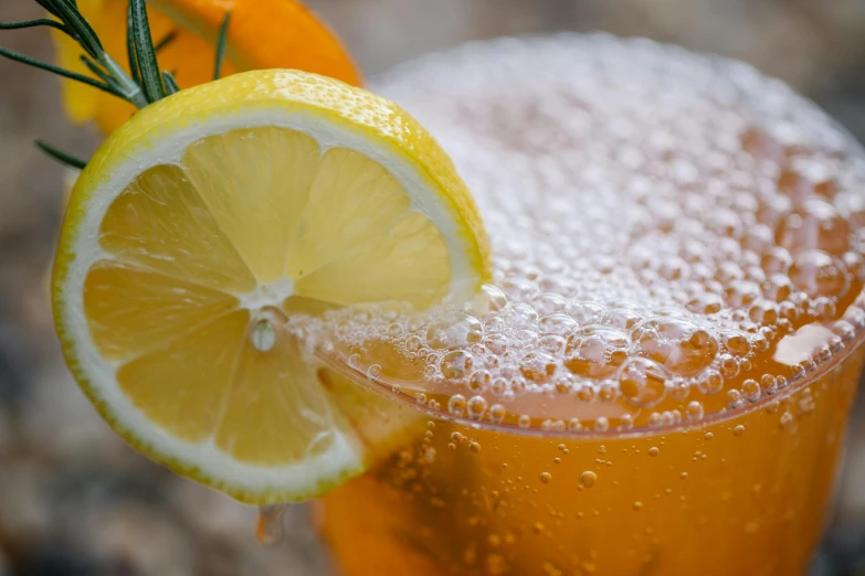 a close up of a drink with a lemon slice, by Tuvia Beeri, pexels, renaissance, orange: 0.5, bubbles, fan favorite, manuka