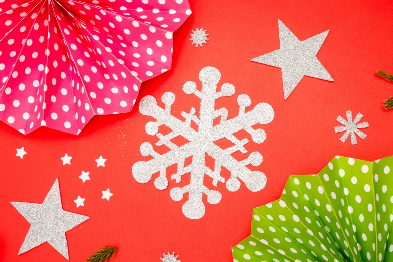 a bunch of paper snowflakes sitting on top of a red surface, by Julia Pishtar, trending on pexels, pop art, background image, polka dot, with fluo colored details, emma bridgewater and paperchase