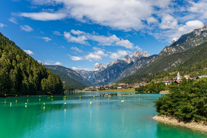a body of water with mountains in the background, by Carlo Martini, pexels contest winner, renaissance, square, green waters, thumbnail, beautiful small town