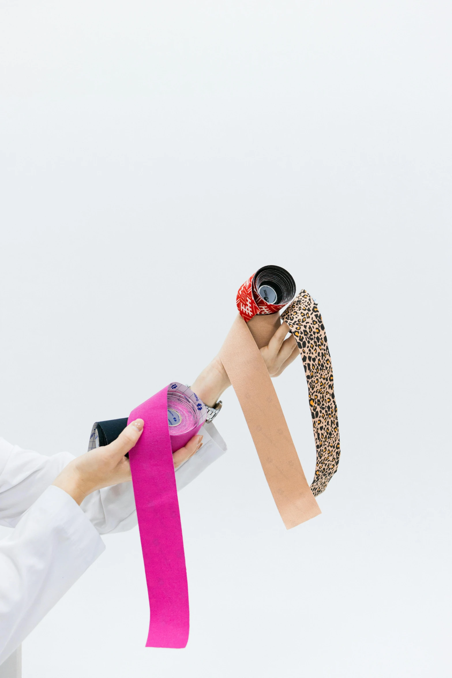 a woman in a white shirt holding a pink ribbon, by Nina Hamnett, trending on unsplash, with a robotic arm, with a white background, patterned, disposable colored camera