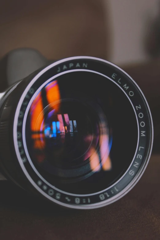 a close up of a camera lens on a table, by Adam Marczyński, bright colors ultrawide lens, looking into camera, reflective lens, looking straight into camera